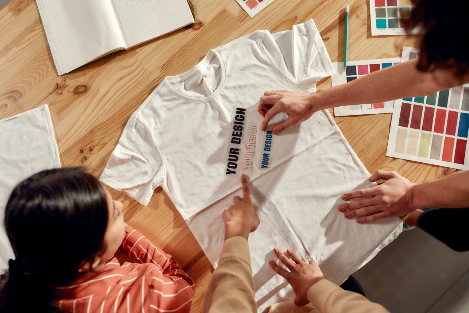 Designers reviewing t-shirt print design options.